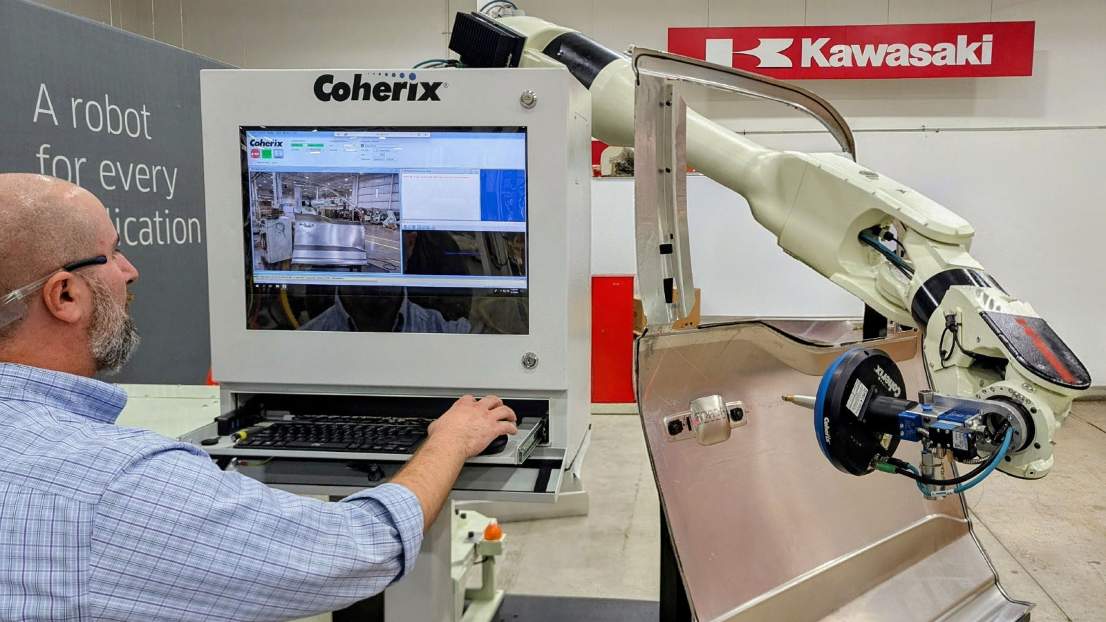 Steven Pagalos, Coherix technical account manager, configures Coherix’s 3D adhesive inspection technology on a door skin during setup for the Kawasaki Robotics exhibit at Automate 2026.
