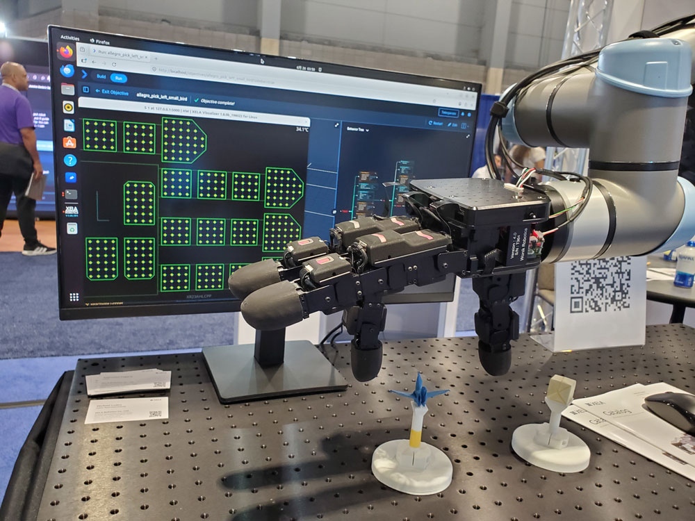 Xela Robotics' robotic hand lifting a delicate paper crane at Automate 2026